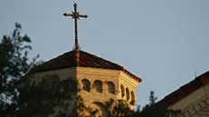 epa07575392 A cross stands on the top of Holy Trinity Catholic Church across the street from the Catholic Diocese of Dallas 16 May 2019 in Dallas, Texas, USA, a day after authorities had conducted a raid on the Catholic Diocese of Dallas. Dallas police searched the headquarters of the Catholic diocese of Dallas and other properties on Wednesday as part of the church's expanding child sex abuse scandal, police and church officials said. EPA/LARRY W. SMITH