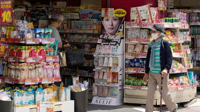 epa11365302 A passerby walks past a drugstore in Tokyo, Japan, 24 May 2024. According to data released by the Japanese government, the national consumer price index was up 2.2 percent from the same month last year. This represents the 32nd consecutive month of increase. EPA/FRANCK ROBICHON