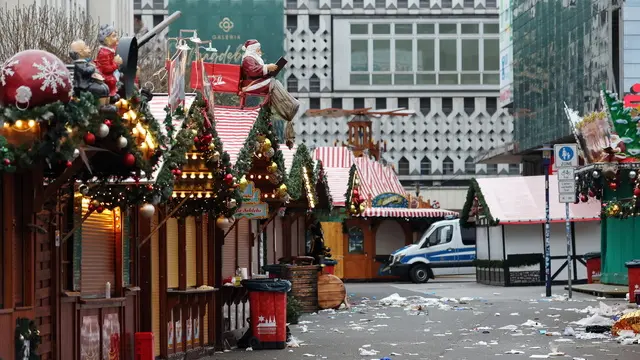 epa11787966 A police vehicle is stationed at the scene of a vehicle-ramming attack on the Christmas market ahead of German Chancellor's visit, in Magdeburg, Germany, 21 December 2024. According to the Magdeburg police, at least two people were confirmed dead, scores were injured, and the suspect, a Saudi national, was taken into custody after he drove a car into a crowd at Magdeburg's Christmas market on 20 December. EPA/FILIP SINGER