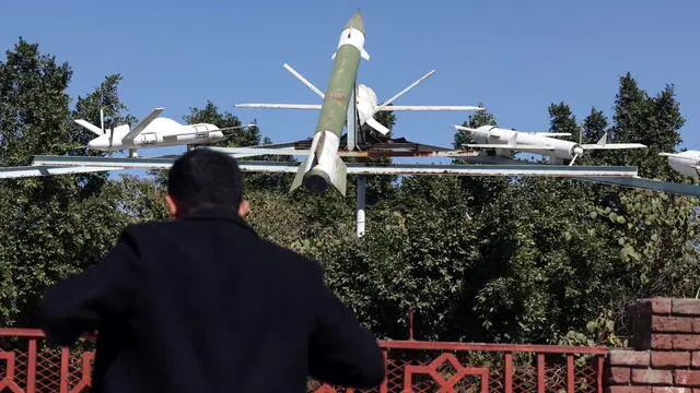 epa11788278 A person looks at a display of Houthis-made mock missiles and drones at a square in Sana'a, Yemen, 21 December 2024. Yemen's Houthis have claimed responsibility for launching a ballistic missile attack on Israel, said Houthi military spokesman Yahya Sarea. The Israeli army confirmed that a missile fired from Yemen managed to evade air defense systems hitting the Tel Aviv-Jaffa area early on 21 December. EPA/YAHYA ARHAB