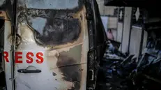 epa11793696 A destroyed vehicle near Al Awda hospital following an Israeli airstrike in Al Nuseirat refugee camp, central Gaza Strip, 26 December 2024. According to the Government Media Office (GMO) in Gaza, five journalists from the 'Al-Quds Today' TV satellite channel were killed after an overnight Israeli airstrike hit their vehicle in Al Nuseirat camp, central Gaza. More than 45,000 Palestinians and over 1,400 Israelis have been killed, according to the Palestinian Health Ministry and the Israeli Army, since Hamas militants launched an attack against Israel from the Gaza Strip on 07 October 2023, and the Israeli operations in Gaza and the West Bank which followed it. EPA/MOHAMMED SABER