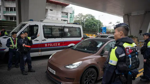 epa11728426 Police officers stand guard outside ofÂ the West Kowloon Magistrates' Court before hearing the sentence for 45 Hong Kong pro-democracy activists in Hong Kong, China, 19 November 2024. Out of the 47 Hong Kong pro-democracy activists arrested in 2021, 45 were sentenced in the city's largest national security trial. EPA/LEUNG MAN HEI