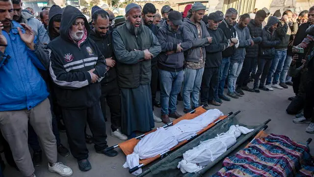 epa11780163 Palestinians pray in front of bodies of their relatives, after an Israeli air strike hit a UNRWA-run school, housing displaced people, in Khan Younis, southern Gaza Strip, 16 December 2024. According to medics at Nasser Hospital, at least 15 Palestinians were killed in the Israeli airstrike. More than 45,000 Palestinians and over 1,400 Israelis have been killed, according to the Palestinian Health Ministry and the Israeli Army, since Hamas militants launched an attack against Israel from the Gaza Strip on 07 October 2023, and the Israeli operations in Gaza and the West Bank which followed it. EPA/HAITHAM IMAD