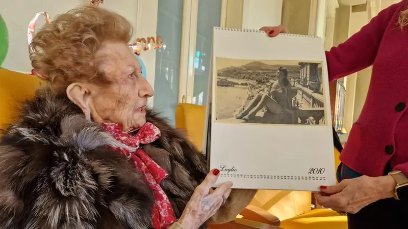 Giustina osserva una sua foto d'epoca - © www.giornaledibrescia.it