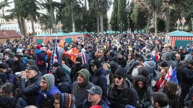 epa11796949 People listen to outgoing Georgian President Salome Zourabichvili's statement outside the Orbeliani Palace in Tbilisi, Georgia, 29 December 2024. Georgian lawmakers elected Mikheil Kavelashvili as the country's new president on 14 December in a controversial parliamentary vote that sparked accusations of illegitimacy and protests. Kavelashvili will be inaugurated as President of Georgia on 29 December 2024.Â EPA/DAVID MDZINARISHVILI