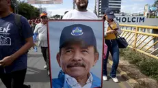 epa10462390 A demonstrator marches with a picture of Nicaragua President Daniel Ortega, in Managua, Nicaragua, 11 February 2023. Hundreds of supporters of the pro-government Sandinista National Liberation Front (FSLN) took to the streets in different Nicaraguan cities to celebrate the expulsion of 222 Nicaraguans critical of the government and accused of treason. EPA/Jorge Torres