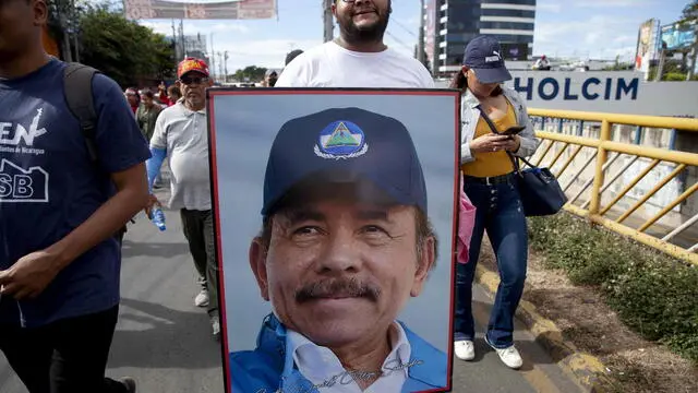 epa10462390 A demonstrator marches with a picture of Nicaragua President Daniel Ortega, in Managua, Nicaragua, 11 February 2023. Hundreds of supporters of the pro-government Sandinista National Liberation Front (FSLN) took to the streets in different Nicaraguan cities to celebrate the expulsion of 222 Nicaraguans critical of the government and accused of treason. EPA/Jorge Torres