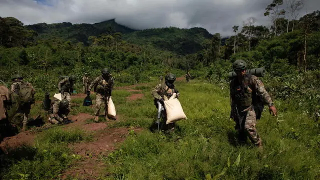 epa10010754 Members of the Peruvian Armed Forces participate in an operation to destroy a clandestine airstrip in the mountains of the Valle de los Rios Apurimac, Ene y Mantaro, also known as the VRAEM, in the Peruvian Amazon, Peru, 07 June 2022 (issued 13 June 2022). On board a helicopter loaded with more than 300 kilos of explosives, members of the Peruvian Armed Forces took off to neutralize landing strips used to export drugs from the country's largest coca-growing region. The operation carried out on 07 June disabled the eighth landing strip out of the fifteen that authorities have located in the VRAEM area, where most of Peru's cocaine comes from. EPA/Sebastian Montalvo Gray ACOMPAÃ‘A CRÃ“NICA: PERÃš NARCOTRÃFICO