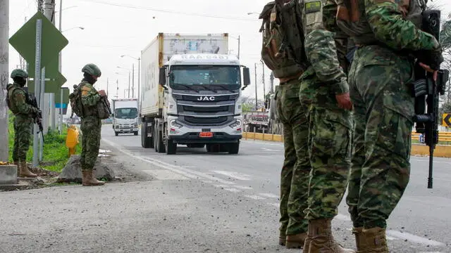 epa11072012 Soldiers from the Guayaquil Infantry Battalion guard the exit of the city to the canton of Daule, in Guayaquil, Ecuador, 12 January 2024. Following a string of prison riots, Ecuadorian President Daniel Noboa declared a state of exception on 08 January. Ecuador has been experiencing a security crisis and extreme violence since ten people were killed in different attacks, which included the temporary takeover of a television station by an armed group in Guayaquil, the burning of cars, and threats against universities, government institutions, and businesses. The security of Guayaquil and four other cities in the coastal province of Guayas, one of the epicenters of the violence crisis, is being reinforced with the presence of more police and military. EPA/CARLOS DURAN ARAUJO