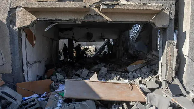 epa11802271 Palestinians inspect the site of an Israeli airstrike in Khan Yunis in the southern Gaza Strip, 02 January 2025. According to Nasser Hospital, at least six Palestinians were killed in an Israeli airstrike on the Hamas-run Interior Ministry headquarters in Gaza. More than 45,300 Palestinians and over 1,400 Israelis have been killed, according to the Palestinian Health Ministry and the Israeli Army, since Hamas militants launched an attack against Israel from the Gaza Strip on 07 October 2023, and the Israeli operations in Gaza and the West Bank which followed it. EPA/HAITHAM IMAD