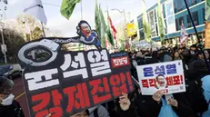 epa11803234 Members of the Korean Confederation of Trade Unions (KCTU) hold placards reading 'Arrest Yoon Suk Yeol immediately' during a rally against impeached president Yoon near the presidential residence in Seoul, South Korea, 03 January 2025. A Seoul court on 31 December 2024 issued an arrest and search warrant to detain impeached president Yoon over his short-lived imposition of martial law. The Corruption Investigation Office (CIO) on 03 January suspended the execution of the arrest warrant and announced that its investigators were leaving the presidential residence after a standoff with the Presidential Security Service (PSS). EPA/JEON HEON-KYUN