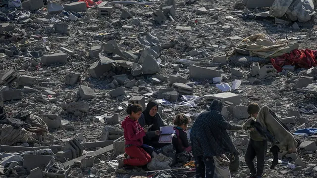 epa11803407 Palestinians inspect the destroyed house of the Abu Libda family following an Israeli air strike in Al Maghazi refugee camp, central Gaza Strip, 03 January 2025. According to reports from the Ministry of Health in Gaza at least nine members of the Abu Libda family were killed following an Israeli air strike in the refugee camp. More than 45,500 Palestinians and over 1,400 Israelis have been killed, according to the Palestinian Health Ministry and the Israeli Army, since Hamas militants launched an attack against Israel from the Gaza Strip on 07 October 2023 and the Israeli operations in Gaza and the West Bank that followed it. EPA/MOHAMMED SABER