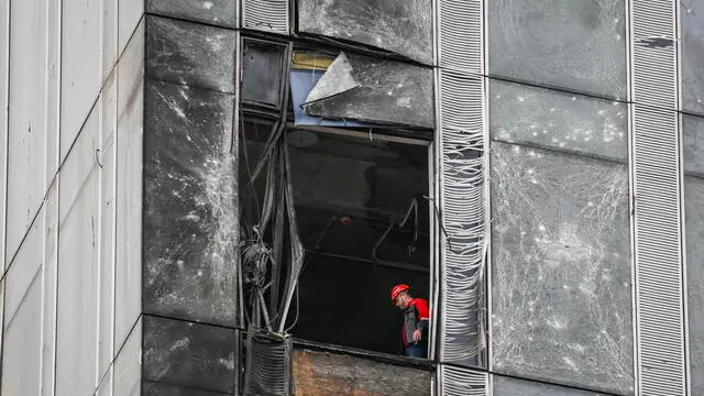 epaselect epa10814856 A worker inside a damaged building in the Moscow-City business center after a drone reportedly fell, in Moscow, Russia, 23 August 2023. The Russian Defence Ministry reported that the air defense forces stopped an attempt by Ukraine to carry out an attack by three unmanned aerial vehicles in Moscow. â€˜Two of the drones were destroyed by air defense in the air over the territory of Mozhaisk and Khimki districts of the Moscow region. The third UAV was suppressed by electronic warfare and, having lost control, collided with the building of the Moscow City business center,â€™ the Russian Defence Ministry said. EPA/YURI KOCHETKOV