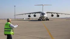 epaselect epa11801150 A Syrian official guides a Saudi Arabian aircraft carrying humanitarian aid, food, shelter and medical materials at Damascus International Airport, in Damascus, Syria on 01 January 2025. EPA/MOHAMMED AL RIFAI