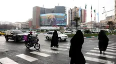 epa11799916 Veiled Iranian women walk past a large-scale billboard showing the late Iranian Revolutionary Guards Corps (IRGC) Lieutenant General and commander of the Quds Force, Qasem Soleimani, ahead of his fifth assassination anniversary in Tehran, Iran, 31 December 2024. Iran will mark the fifth anniversary of Soleimani's death on 02 January 2025. Soleimani was killed on 03 January 2020 in a targeted US airstrike at Baghdad airport in Iraq. EPA/ABEDIN TAHERKENAREH