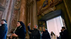 Pilgrims pass the Holy Door of St Peter's Basilica in the Vatican after the start of the Catholic Jubilee Year, 25 December 2024