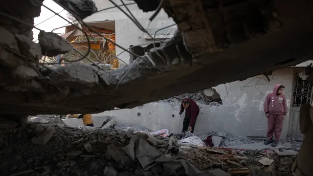 epa11812647 Palestinians inspect the site of an Israeli airstrike in the Khan Yunis camp in southern Gaza, 08 January 2025. At least 20 Palestinians were killed following an Israeli airstrike targeting residential areas in Khan Younis, according to medics at Nasser Hospital. More than 45,800 Palestinians and over 1,400 Israelis have been killed, according to the Palestinian Health Ministry and the Israeli Army, since Hamas militants launched an attack against Israel from the Gaza Strip on 07 October 2023, and the Israeli operations in Gaza and the West Bank which followed it. EPA/HAITHAM IMAD