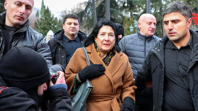 epa11776033 Georgian President Salome Zurabishvili (C) and supporters of the opposition attend a protest in front of the parliament building during presidential elections in Tbilisi, Georgia, 14 December 2024. For the first time in Georgia, the president is being elected by an electoral college in the parliament building. President Zurabishvili, declaring herself the only lawful representative of power in the country, said that she would not resign from her post, stating that "with an illegitimate parliament, there cannot be legitimate presidential elections". EPA/DAVID MDZINARISHVILI