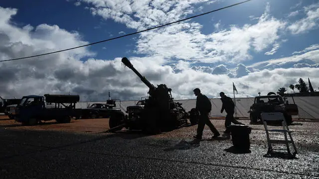 epaselect epa11799945 Israeli soldiers walk next to military weapons displayed for the media at Amiad military camp, northern Israel, 31 December 2024. According to the Israeli army, the equipment and weapons were uncovered throughout the ground operation in south Lebanon. A 60-day ceasefire agreement between Israel and Hezbollah came into force on 27 November 2024. EPA/ATEF SAFADI