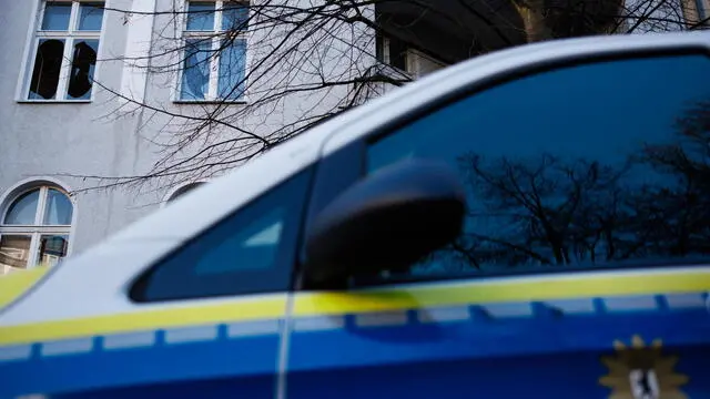 epa11802221 A police car stands in front of a pane of windows of a residential building that are in a destroyed state in Berlin, Germany, 02 January 2025. The Berlin fire department announced in a summary of the events on New Year's Eve in Berlin that 36 apartments became uninhabitable after the implementation of pyrotechnics around the Schoeneberg district street Belziger Strasse. EPA/CLEMENS BILAN