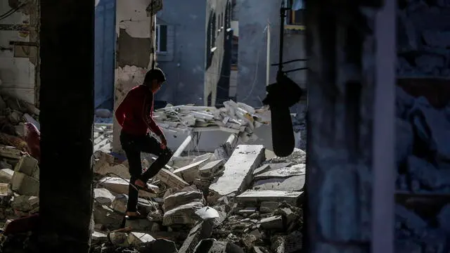 epa11814582 A Palestinian boy inspects his family's destroyed house following an Israeli air strike on Deir Al Balah refugee camp, central Gaza Strip, 09 January 2025. According to the Palestinian Ministry of Health in Gaza, at least six Palestinians were killed and more than 12 others injured on 08 January after an Israeli airstrike hit Deir Al Balah refugee camp in central Gaza. More than 45,800 Palestinians and over 1,400 Israelis have been killed, according to the Palestinian Health Ministry and the Israeli Army, since Hamas militants launched an attack against Israel from the Gaza Strip on 07 October 2023, and the Israeli operations in Gaza and the West Bank which followed it. EPA/MOHAMMED SABER