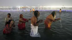 epaselect epa11819536 Hindu devotees take a 'holy bath' at Sangam, the confluence of three of the holiest rivers in Hindu mythology - Ganga, Yamuna, and the mythical Saraswati - in Prayagraj, Uttar Pradesh, India, 12 January 2025. Every 12 years, Hindu pilgrims gather for ritual baths at the river's banks during the Maha Kumbh Mela festival. EPA/RAJAT GUPTA