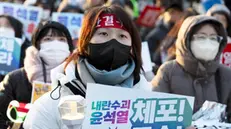 epa11817984 Members of Civic groups hold baners reading 'Immediate arrest' during a rally in Seoul, South Korea, 11 January 2025. On 07 January 2025, a court refiled a warrant to extend the deadline to detain Yoon over his failed bid to impose martial law in December 2024. EPA/JEON HEON-KYUN