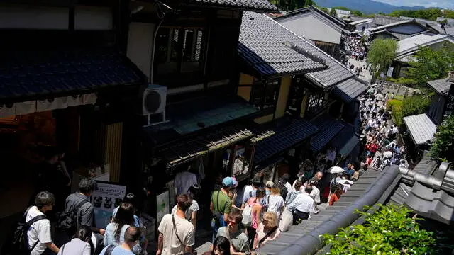 epa11377381 Tourists crowd a street leading to Kiyomizu-dera temple, a famous tourist destination near Gion district, in Kyoto, western Japan, 29 May 2024. Gion, the famous Maiko and Geisha district of Kyoto, has begun to apply access restrictions on its streets in the face of overtourism, illustrating Japan's difficulties in dealing with the record number of foreign travelers that the country has been receiving in recent months.Â EPA/FRANCK ROBICHON