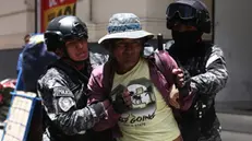 epa11825027 Police officers detain a person during a protest in La Paz, Bolivia, 14 January 2025. Bolivian police kept all the entrances to the center of political power where the seats of government and the legislature are located, closed and under heavy guard, to prevent the passage of street protests by supporters of former president Evo Morales (2006-2019). EPA/Luis Gandarillas