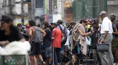 epa10794130 Homeless people and drug addicts stand in an area known as 'Cracolandia' in the center of Sao Paulo, Brazil 10 August 2023. The term 'Cracolandias' refers to areas with high levels of street-based homelessness and public drug use, located in various Brazilian cities. Dozens of merchants in downtown Sao Paulo lowered their stores' blinds on 10 August to protest about having become neighbors of the highest concentration of drug users in the city. EPA/Sebastiao Moreira