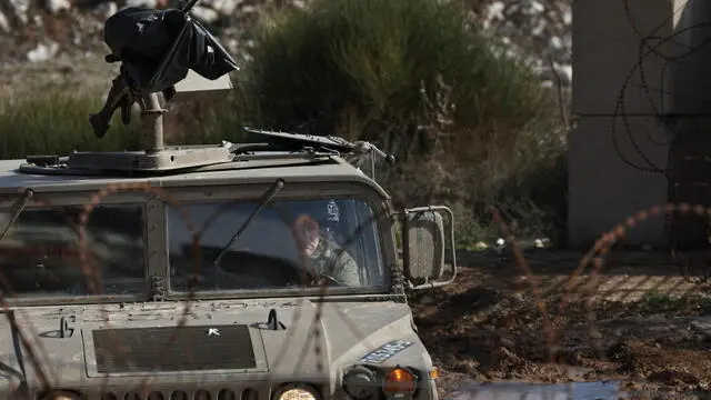 epaselect epa11807327 An Israeli military vehicle patrols along the security fence between Israel and Syria, near the Druze village of Majdal Shams, in the Israeli-annexed Golan Heights, 05 January 2025. Israel's military said that paratroopers' forces, joined by other troops, are conducting 'defense activities' to prevent 'any threat' and are deployed in key positions within the buffer zone. EPA/ATEF SAFADI