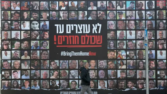 epa11825874 A man walks past a billboard showing images of Israeli hostages held by Hamas in Gaza reading 'Don't stop until everyone is back', in Jerusalem, 15 January 2025. According to Israel's military, around 100 Israeli hostages remain in captivity in the Gaza Strip, including the bodies of 33 confirmed dead. More than 46,500 Palestinians and over 1,400 Israelis have been killed, according to the Palestinian Health Ministry and the Israeli Army, since Hamas militants launched an attack against Israel from the Gaza Strip on 07 October 2023, and the Israeli operations in Gaza and the West Bank which followed it. EPA/ABIR SULTAN