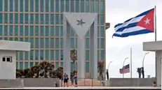 epa11826826 Tourists stand outside the US Embassy in Havana, Cuba, 15 January 2025. Cuban authorities clarified that the 553 people to be released from the island's prisons have neither been pardoned nor amnestied - but rather, technically, released from prison - and therefore 'may return to prison' if they do not meet a series of 'requirements', such as 'good conduct'. The Cuban government announced on 14 January the release of prisoners following negotiations with the Vatican. EPA/ERNESTO MASTRASCUSA