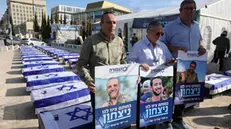 epa11828073 Families of fallen Israeli soldiers stand near a display of mock coffins draped in Israeli flags during a protest against a ceasefire deal between Israel and the Palestinian militant group Hamas, outside the Supreme Court in Jerusalem, 16 January 2025. Israel and Hamas agreed on a hostage release deal and a Gaza ceasefire to be implemented in the coming days following months of war, US and Qatari officials announced on 15 January. Israel's security cabinet is expected to meet on 16 January to approve the agreement. EPA/ABIR SULTAN