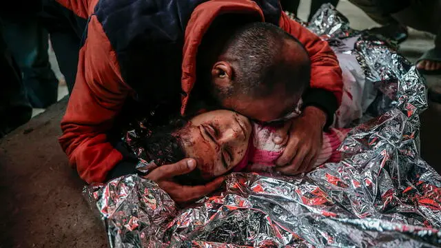 epa11819038 GRAPHIC CONTENT - A Palestinian man, Adli, mourns over the body of his five-year-old daughter, Dima, at Al Aqsa Martyrs Hospital in Deir Al Balah, central Gaza Strip, 11 January 2025. According to the Palestinian Ministry of Health in Gaza, at least three members of a Palestinian family were killed after an Israeli airstrike hit Deir Al Balah, central Gaza. More than 45,800 Palestinians and over 1,400 Israelis have been killed, according to the Palestinian Health Ministry and the Israeli Army, since Hamas militants launched an attack against Israel from the Gaza Strip on 07 October 2023, and the Israeli operations in Gaza and the West Bank which followed it. EPA/MOHAMMED SABER -- ATTENTION EDITORS: GRAPHIC CONTENT