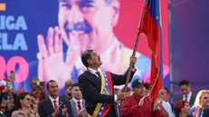 epa11817532 Venezuelan President Nicolas Maduro holds a flag during an event in Caracas, Venezuela, 10 January 2025. Maduro defended his presidential investiture for a third six-year term, questioned by anti-Chavismo and much of the international community following opposition allegations of â€œfraudâ€ during last years July presidentail elections, as a â€œgreat Venezuelan victoryâ€ and celebrated that it could not be â€œpreventedâ€. EPA/RONALD PENA R.