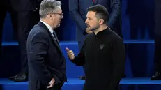 epa11707498 British Prime Minister Keir Starmer and Ukrainian President Volodymyr Zelensky have a chat prior to a group photo during the 5th summit of the European Political Community (EPC) in Puskas Arena in Budapest, Hungary, 07 November 2024. EPA/TAMAS KOVACS HUNGARY OUT