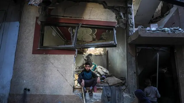 epa11814589 A Palestinian boy inspects his family's destroyed house following an Israeli air strike on Deir Al Balah refugee camp, central Gaza Strip, 09 January 2025. According to the Palestinian Ministry of Health in Gaza, at least six Palestinians were killed and more than 12 others injured on 08 January after an Israeli airstrike hit Deir Al Balah refugee camp in central Gaza. More than 45,800 Palestinians and over 1,400 Israelis have been killed, according to the Palestinian Health Ministry and the Israeli Army, since Hamas militants launched an attack against Israel from the Gaza Strip on 07 October 2023, and the Israeli operations in Gaza and the West Bank which followed it. EPA/MOHAMMED SABER