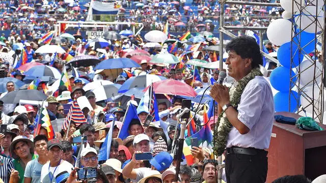 epa11784586 Former Bolivian President Evo Morales (R) speaks to supporters during an event at the Chimore stadium, Bolivia, 18 December 2024. A crowd of Morales' supporters proclaimed him as the 'sole candidate' for the 2025 elections, even if he is imprisoned over the aggravated human trafficking case for which there is an arrest warrant against him. EPA/Jorge Abrego