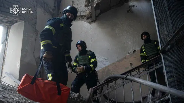 epa11801356 A handout photo made available by the State Emergency Service shows Ukrainian rescuers working at the site of a drone attack on a residential building in Kyiv, Ukraine, 01 January 2025. According to the State Emergency Service, the Russian drone attack in Kyiv killed at least two people and injured six more. Russian troops entered Ukraine on 24 February 2022, starting a conflict that has provoked destruction and a humanitarian crisis. EPA/STATE EMERGENCY SERVICE HANDOUT HANDOUT EDITORIAL USE ONLY/NO SALES
