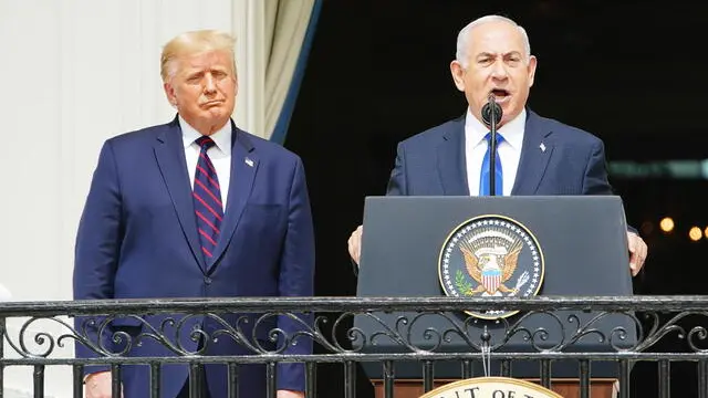 epa08671174 Israeli Prime Minister Benjamin Netanyahu (R) speaks as US President Donald J. Trump (L) listens during the Abraham Accords signing ceremony, which normalizes relations between the United Arab Emirates and Bahrain with Israel, on the South Lawn of the White House in Washington, DC, USA, 15 September 2020. EPA/JIM LO SCALZO