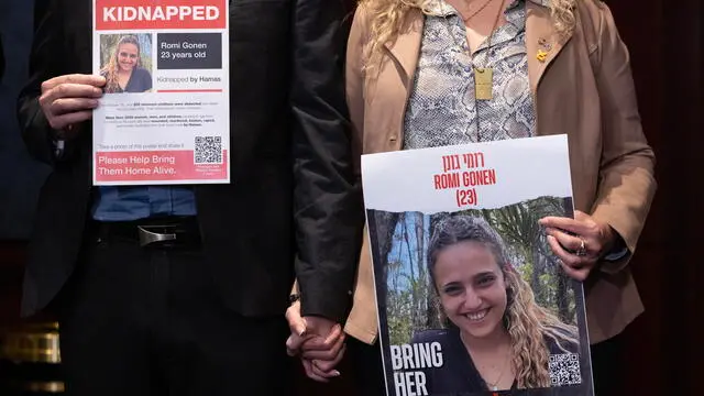 epa11134601 Eitan Gonen (L), father of Romi Gonen, and his partner Meital Shay Waiss (R) hold pictures of Romi Gonen who was taken hostage by Hamas, at an event with US lawmakers, members of the Israeli Knesset, and families of hostages taken by Hamas, on Capitol Hill in Washington, DC, USA, 07 February 2024. A 17.6 billion aid to Israel bill that was put forward in the US House of Representatives as a standalone alternative to a Senate immigration and foreign aid bill, failed on 06 February. EPA/MICHAEL REYNOLDS