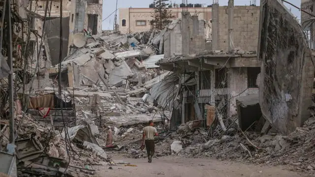 epa11414621 Palestinians walk between rubble of houses before Eid al-Adha prayer in Khan Younis town, southern Gaza strip, 16 June 2024. Eid al-Adha is the holiest of the two Muslims holidays celebrated each year. It marks the yearly Muslim pilgrimage (Hajj) to visit Mecca, the holiest place in Islam. Muslims slaughter a sacrificial animal and split the meat into three parts, one for the family, one for friends and relatives, and one for the poor and needy. EPA/MOHAMMED SABER