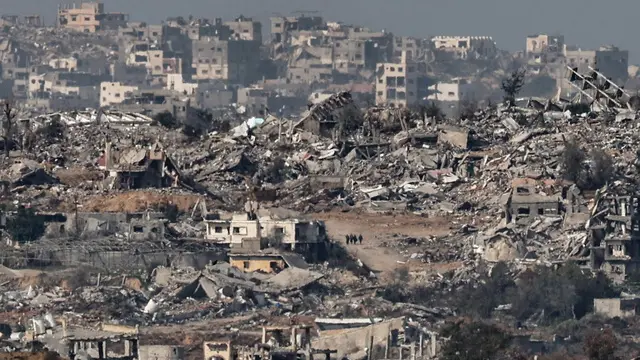 epaselect epa11835700 A group of Palestinians (C, rear) walks among the ruins of damaged buildings in the town of Beit Hanoun in the northern Gaza Strip, as seen from the Israeli-Gaza border near Sderot, southern Israel, 19 January 2025, before a ceasefire in Gaza is set to come into effect. Israel and Hamas agreed on a hostage release deal and a Gaza ceasefire to be implemented on 19 January 2025. More than 46,000 Palestinians have been killed in the Gaza Strip, according to the Palestinian Ministry of Health, since Israel launched a military campaign in the strip in response to a cross-border attack led by the Palestinian militant group Hamas on 07 October 2023, in which about 1,200 Israelis were killed and more than 250 taken hostage. EPA/ATEF SAFADI