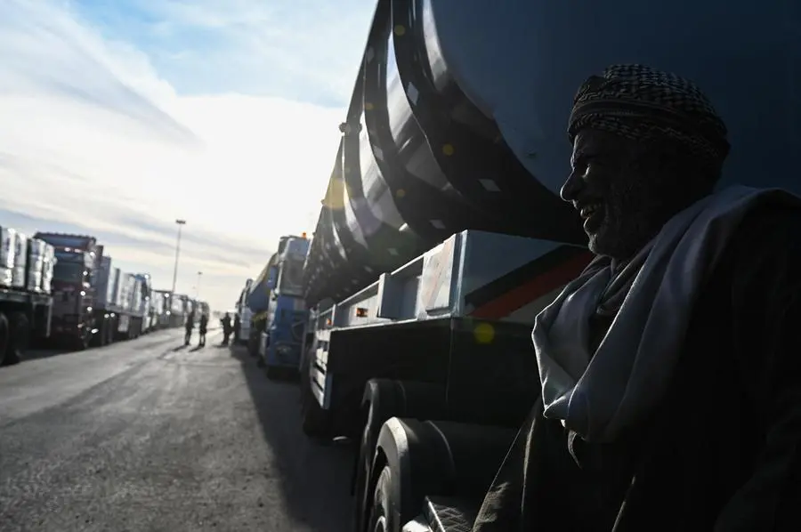 epa11836834 A truck driver prepares his truck of humanitarian aid bound for the Gaza Strip that will cross the Rafah border crossing between the Gaza Strip and Egypt, in Rafah, Egypt, 19 January 2024, after announcement of a ceasefire agreement between Israel and Hamas. More than 46,000 Palestinians have been killed in the Gaza Strip, according to the Palestinian Ministry of Health, since Israel launched a military campaign in the strip in response to a cross-border attack led by the Palestinian militant group Hamas on 07 October 2023, in which about 1,200 Israelis were killed and more than 250 taken hostage. EPA/MOHAMED HOSSAM