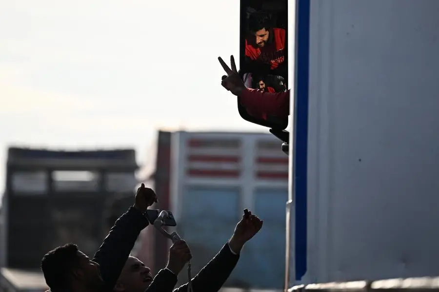 epa11836845 A driver cheers as trucks of humanitarian aid bound for the Gaza Strip cross at the Rafah border crossing between the Gaza Strip and Egypt, in Rafah, Egypt, 19 January 2024, after the announcement of a ceasefire agreement between Israel and Hamas. More than 46,000 Palestinians have been killed in the Gaza Strip, according to the Palestinian Ministry of Health, since Israel launched a military campaign in the strip in response to a cross-border attack led by the Palestinian militant group Hamas on 07 October 2023, in which about 1,200 Israelis were killed and more than 250 taken hostage. EPA/MOHAMED HOSSAM