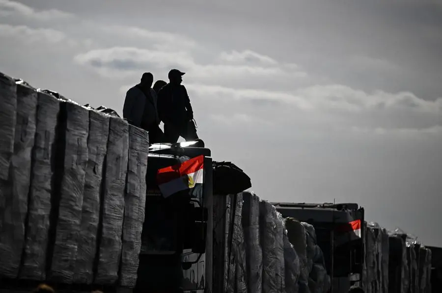 epa11836837 Trucks of humanitarian aid bound for the Gaza Strip wait at the Rafah border crossing between the Gaza Strip and Egypt, in Rafah, Egypt, 19 January 2024, after announcement of a ceasefire agreement between Israel and Hamas. More than 46,000 Palestinians have been killed in the Gaza Strip, according to the Palestinian Ministry of Health, since Israel launched a military campaign in the strip in response to a cross-border attack led by the Palestinian militant group Hamas on 07 October 2023, in which about 1,200 Israelis were killed and more than 250 taken hostage. EPA/MOHAMED HOSSAM