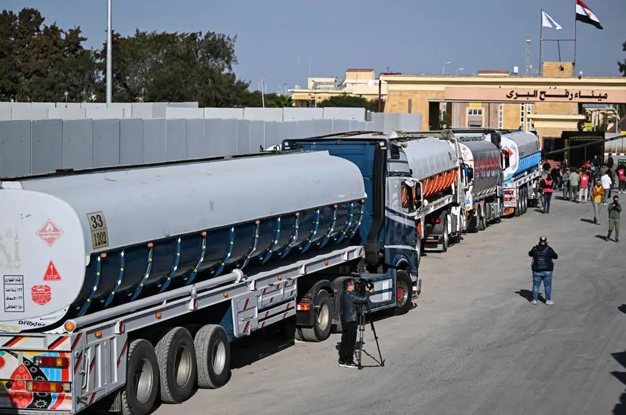 epa11836812 Trucks of humanitarian aid bound for the Gaza Strip cross the Rafah border crossing between the Gaza Strip and Egypt, in Rafah, Egypt, 19 January 2024, after announcement of a ceasefire agreement between Israel and Hamas. More than 46,000 Palestinians have been killed in the Gaza Strip, according to the Palestinian Ministry of Health, since Israel launched a military campaign in the strip in response to a cross-border attack led by the Palestinian militant group Hamas on 07 October 2023, in which about 1,200 Israelis were killed and more than 250 taken hostage. EPA/MOHAMED HOSSAM