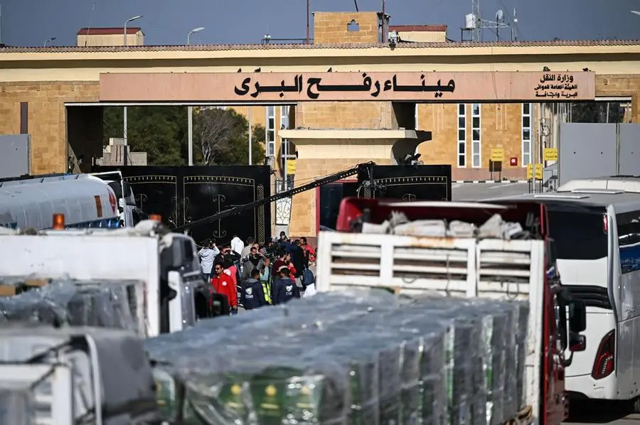 epa11836810 Trucks of humanitarian aid bound for the Gaza Strip cross the Rafah border crossing between the Gaza Strip and Egypt, in Rafah, Egypt, 19 January 2024, after announcement of a ceasefire agreement between Israel and Hamas. More than 46,000 Palestinians have been killed in the Gaza Strip, according to the Palestinian Ministry of Health, since Israel launched a military campaign in the strip in response to a cross-border attack led by the Palestinian militant group Hamas on 07 October 2023, in which about 1,200 Israelis were killed and more than 250 taken hostage. EPA/MOHAMED HOSSAM