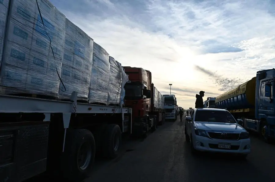 epa11836842 Trucks of humanitarian aid bound for the Gaza Strip cross at the Rafah border crossing between the Gaza Strip and Egypt, in Rafah, Egypt, 19 January 2024, after the announcement of a ceasefire agreement between Israel and Hamas. More than 46,000 Palestinians have been killed in the Gaza Strip, according to the Palestinian Ministry of Health, since Israel launched a military campaign in the strip in response to a cross-border attack led by the Palestinian militant group Hamas on 07 October 2023, in which about 1,200 Israelis were killed and more than 250 taken hostage. EPA/MOHAMED HOSSAM